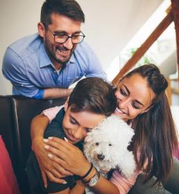 Employee benefits Howden Turkey people smiling and laughing with dog 